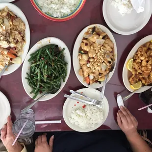 From left are Kung pao cabbage, green beans with garlic and red pepper, Kung pao fish, and lemon chicken.