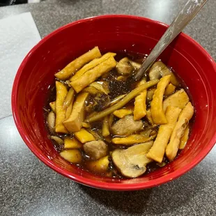 a red bowl filled with mushrooms