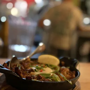 Sigsig: Crispy pork bits marinated in soy sauce and calamansi, topped with a fried egg and chilis