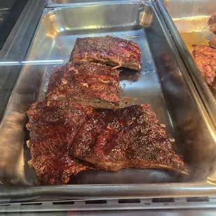 a rack of ribs in a metal pan