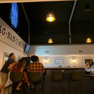 a group of people sitting at a bar