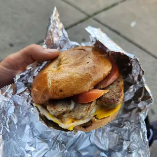 a hand holding a sandwich