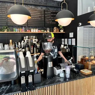 a man preparing a cup of coffee