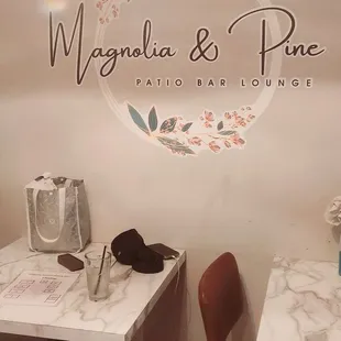 Logo behind host / hostess desk