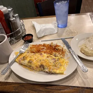 Meat lovers Omelette with biscuit and gravy.
