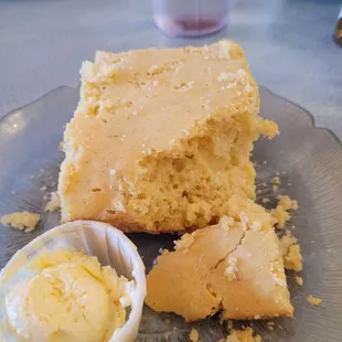 A slice of corn bread with butter..