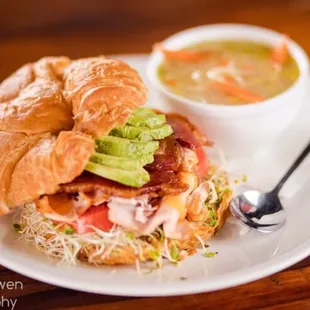 a croissant sandwich and soup