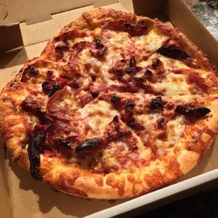 Medium pizza with pepperoni and sun-dried tomatoes.