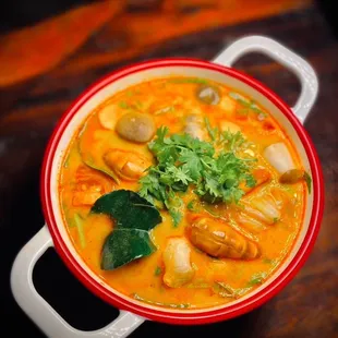 a bowl of soup on a wooden table