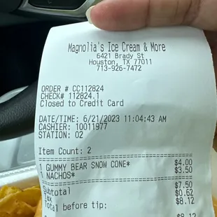 The receipt shows the gummy bear snow cone at $4 but the menu on wall says $3.50 .