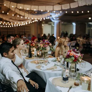 Bridal bouquets on the head table.  (Photographer: Photography and design by Lauren)
