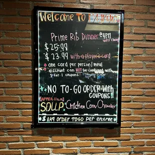 a menu on a brick wall