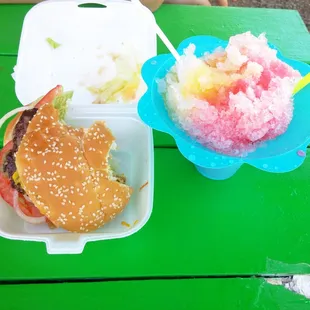 Burger, shaved ice, and a green picnic table to eat it on