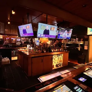 a bar with multiple televisions