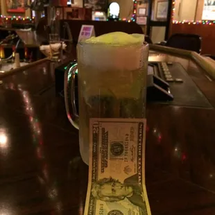 a dollar bill in a mug