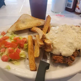 Chicken fried steak, homemade fries, salad, and toast