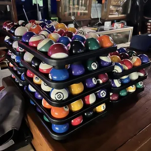 a pile of pool balls on a table