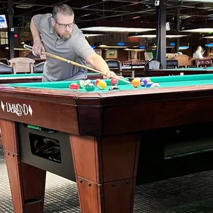a man playing a game of pool