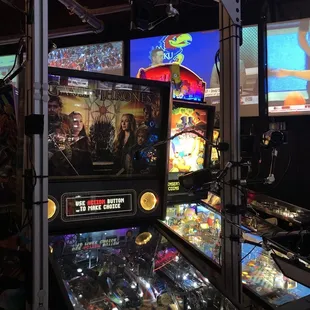 a row of pinball machines in a game room