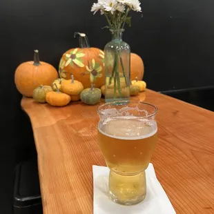 a glass of beer on a wooden table
