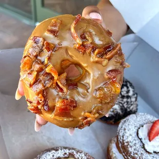a hand holding a donut