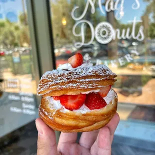 a hand holding a pastry