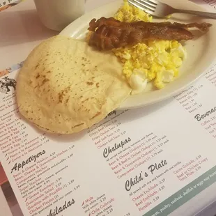 Eggs, bacon and corn tortilla with coffee. Delicious