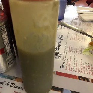 a green drink with a red lid