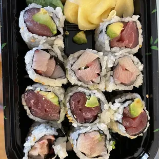 a tray of sushi and vegetables