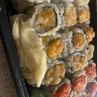 a tray of sushi and rolls