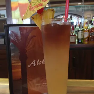 a tall drink with a pineapple garnish