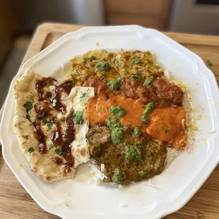 Lamb Vindaloo, Butter Chicken, Saag Lamb and Nizami Korma Chicken. Garlic Naan and Chutney sauces of course.