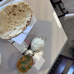 Nan bread, chicken curry, and rice