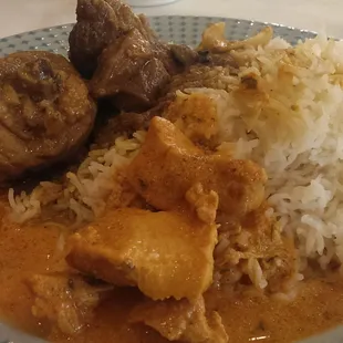 Lunch buffet: rice, butter chicken, lamb curry, and chicken curry