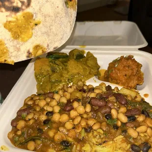 Naan bread, pumpkin curry, chickpeas and kidney beans curry, yellow rice