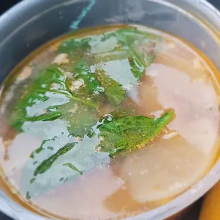 a bowl of soup with broccoli