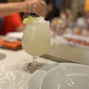 a margarita with a lime garnish