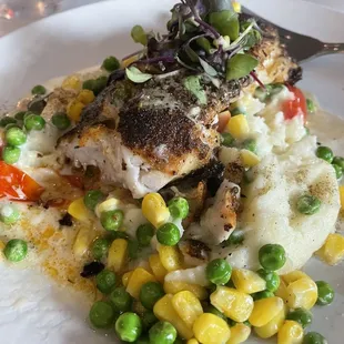 Fresh blackened Tilefish with peas corn and Garlic mashed potatoes.