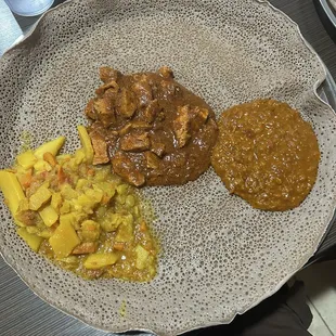 Ethiopian Sample Platter Feeds 1, Dinich Alicha, Doro Wot, and Yemisir Wot from left to right
