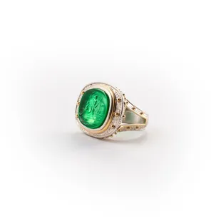 The elegant and timeless beauty of sterling silver and 18 karat gold, especially when anchored with a pungent , emerald green intaglio.