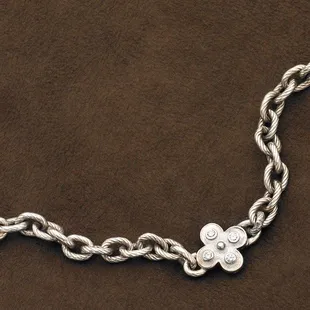 Beautiful, heavy, solid antiqued sterling silver cable bracelet with quatrefoil center medallion , set with four diamonds,