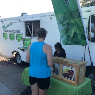 a woman ordering food from a food truck