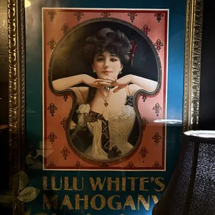 Framed artwork in ladies bathroom