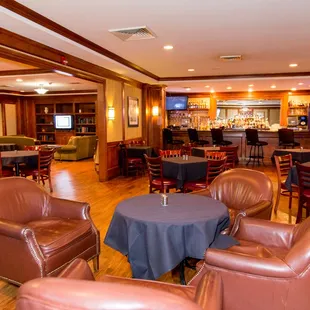 a restaurant with leather chairs and tables