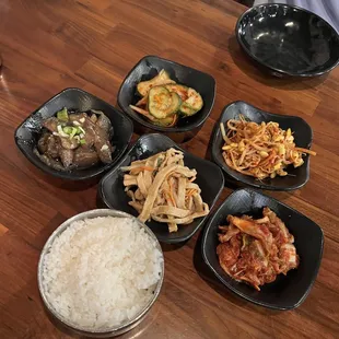 Bon chon-Korean appetizers-kimchee pickled cucumbers, kimchee, fish cake, eggplant