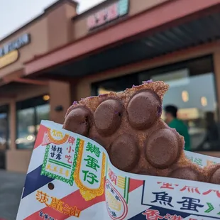 a person holding a bag of donuts