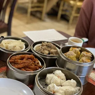 a variety of food in tins on a table
