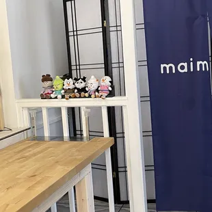 a wooden table with stuffed animals on it