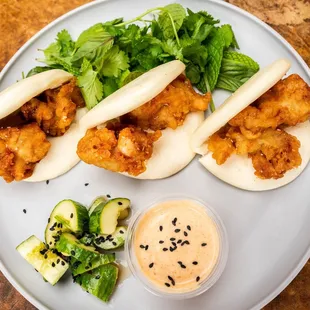 Chicken karaage bao with pickles, herbs, and chorizo aioli
