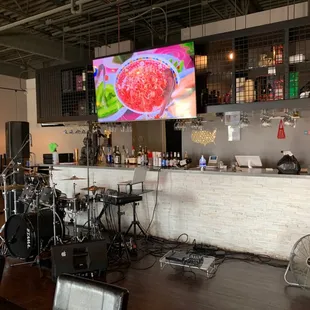 a bar with a large screen in the background